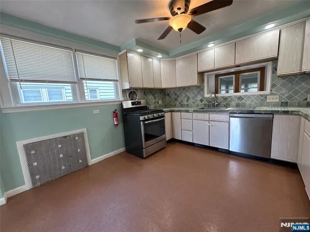 a kitchen with granite countertop a stove and a sink