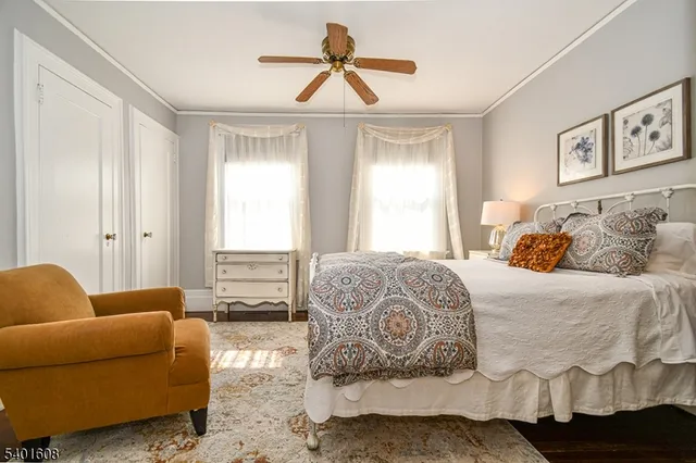 a bedroom with a couch and wooden floor