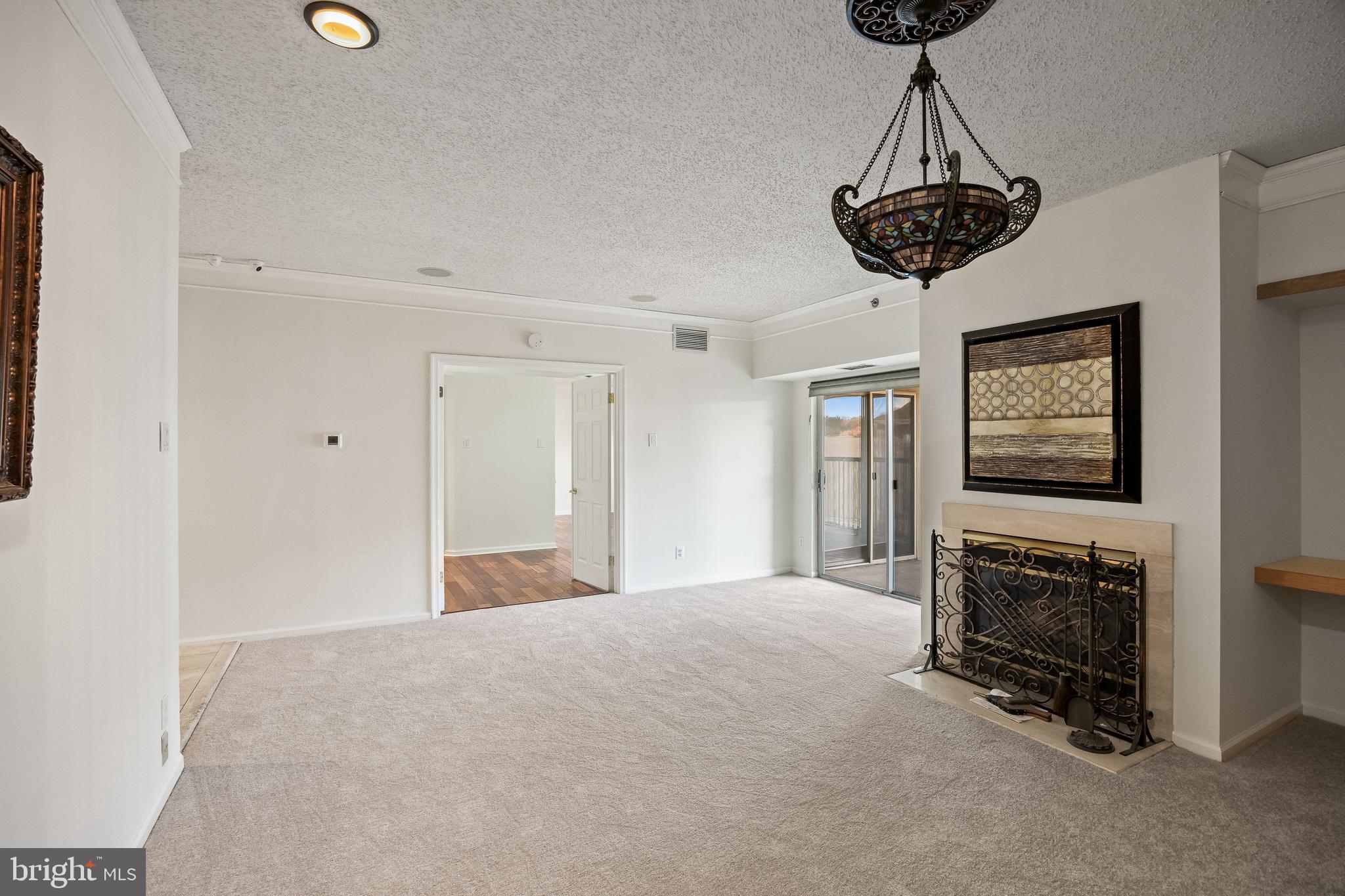 6072 Main Street Voorhees, NJ 08043 - Photo 17 of 41 a view of a livingroom with a fireplace a chandelier and windows