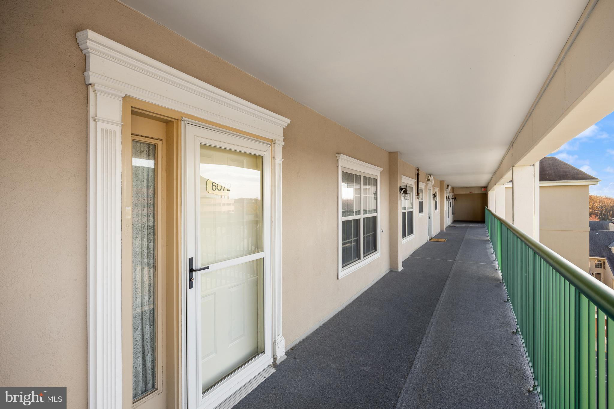 6072 Main Street Voorhees, NJ 08043 - Photo 22 of 41 a view of a hallway with wooden floor and staircase