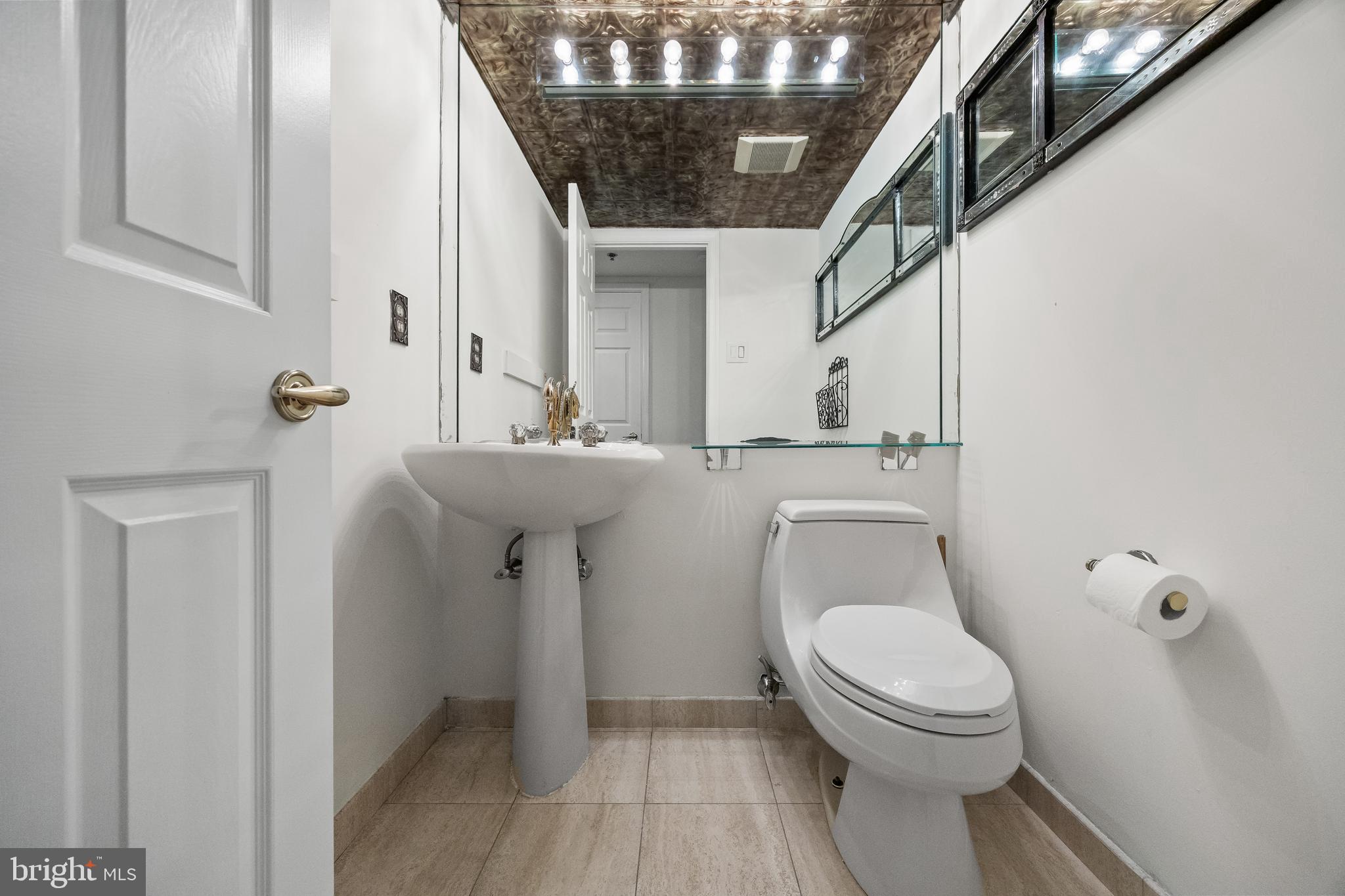 6072 Main Street Voorhees, NJ 08043 - Photo 10 of 41 a bathroom with a toilet a sink and a window