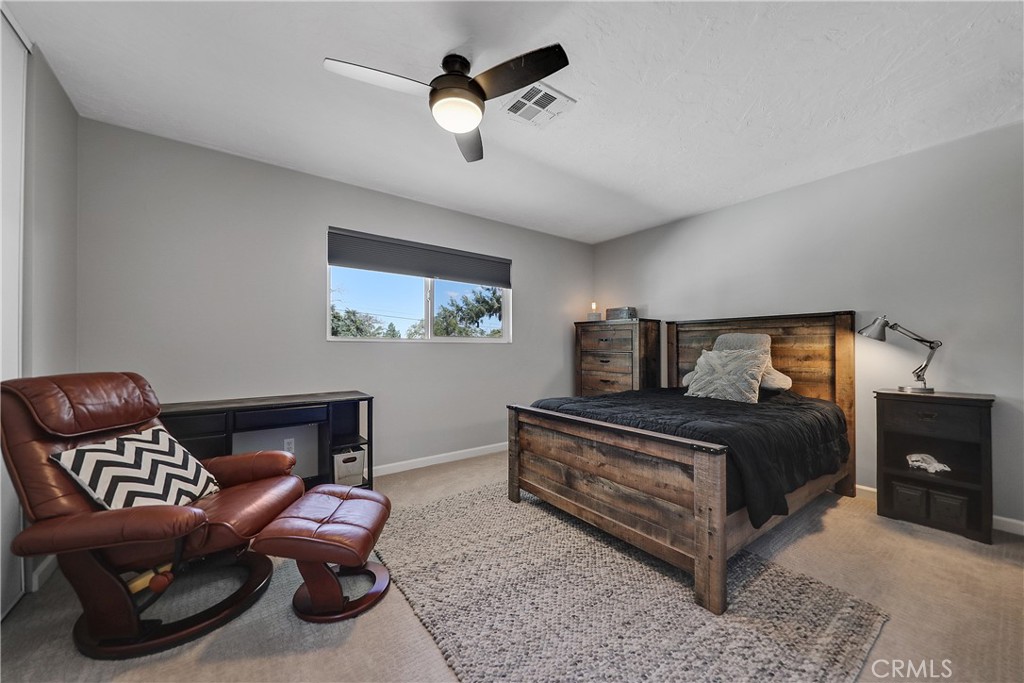 56800 Java Drive Yucca Valley, CA 92284 - Photo 20 of 43 a bedroom with a bed lamp and dresser