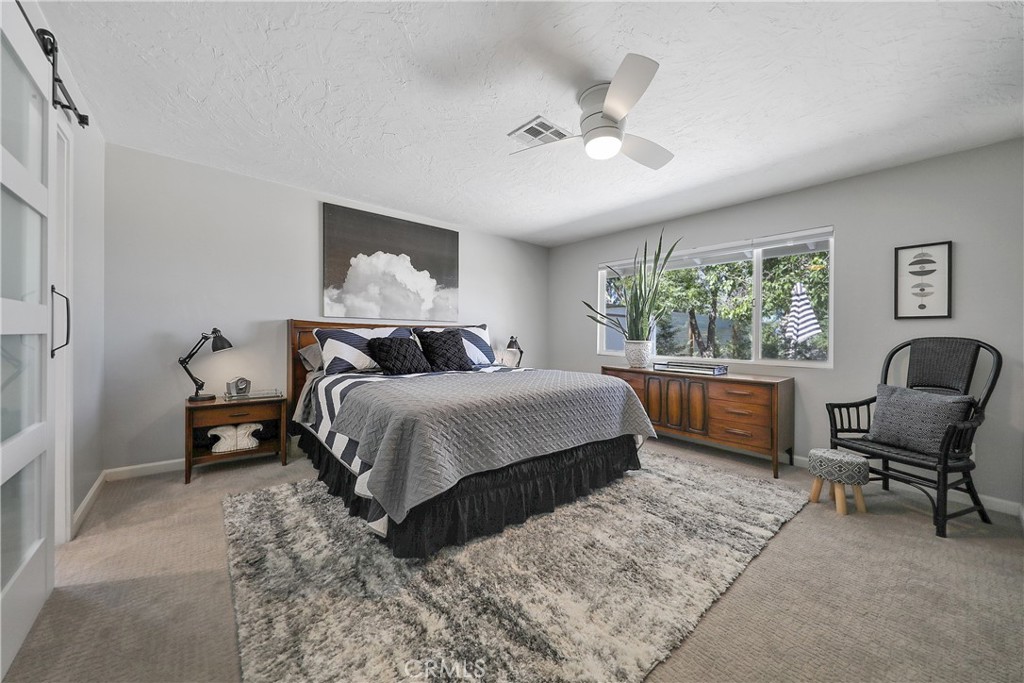 56800 Java Drive Yucca Valley, CA 92284 - Photo 21 of 43 a bedroom with a bed and a chair