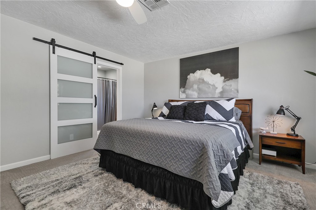 56800 Java Drive Yucca Valley, CA 92284 - Photo 22 of 43 a bedroom with a bed and a window