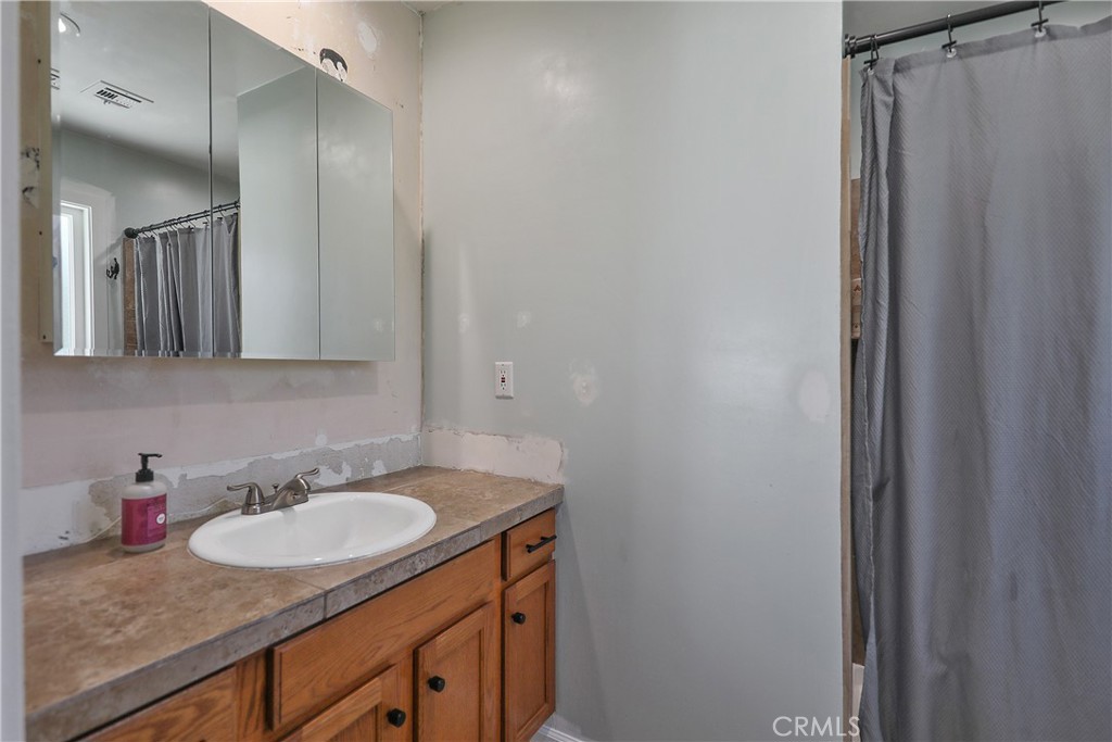 56800 Java Drive Yucca Valley, CA 92284 - Photo 23 of 43 a bathroom with a granite countertop sink and a mirror