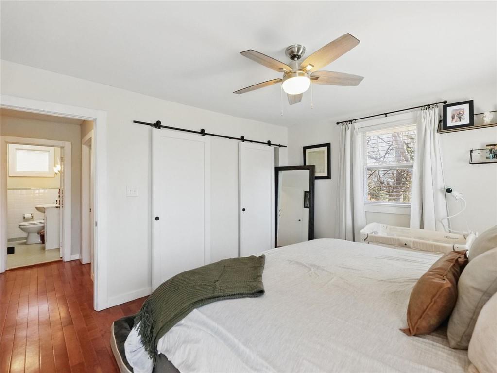 2093 Beverly Road Gainesville, GA 30501 - Photo 11 of 24 a bedroom with a large bed and wooden floor
