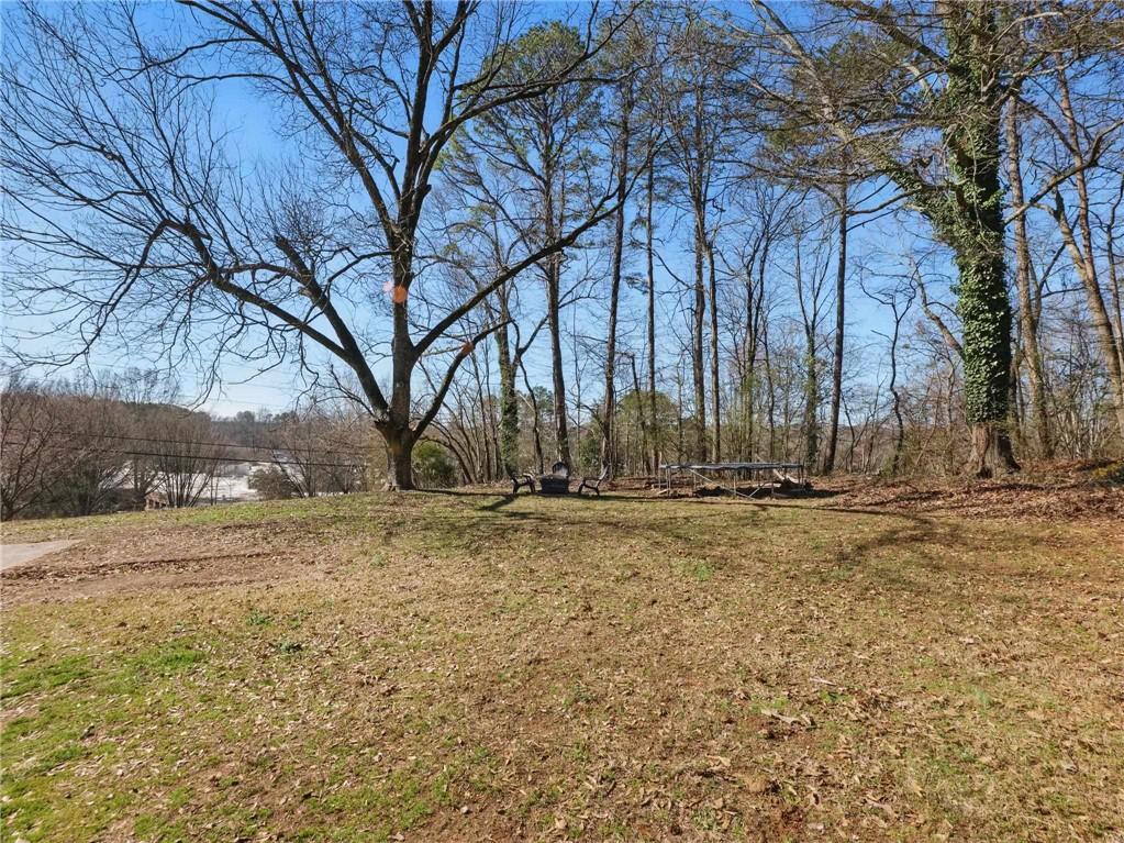2093 Beverly Road Gainesville, GA 30501 - Photo 7 of 24 a view of large trees with wooden fence