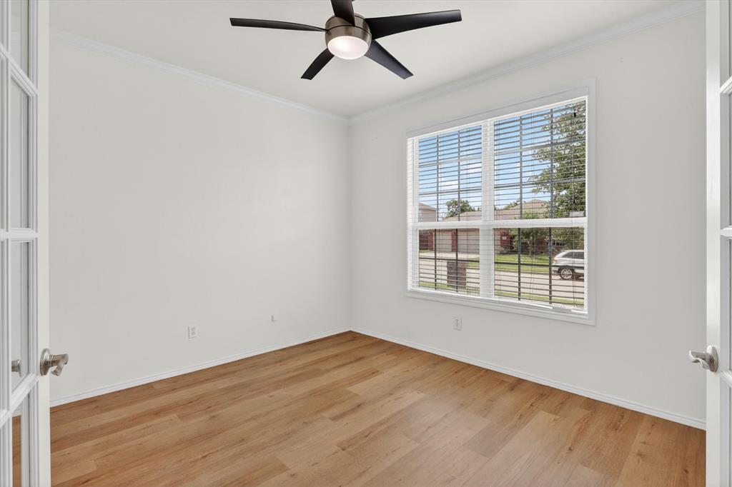 1627 Kawati Way Krum, TX 76249 - Photo 18 of 32 a view of an empty room with a window and wooden floor