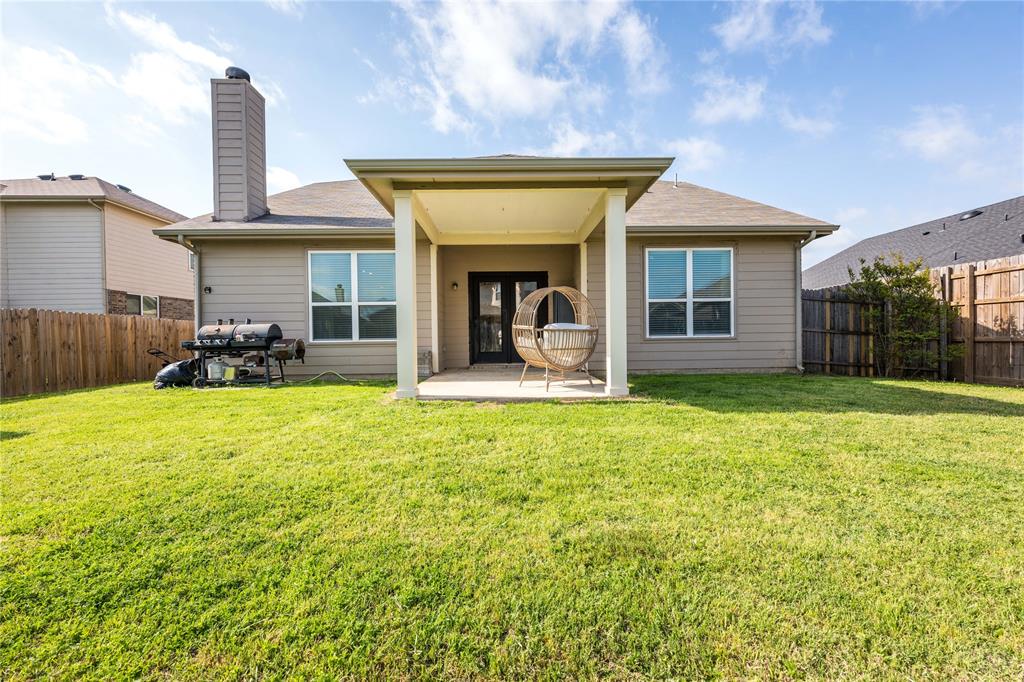 1627 Kawati Way Krum, TX 76249 - Photo 31 of 32 a view of a house with floor to ceiling windows and a yard