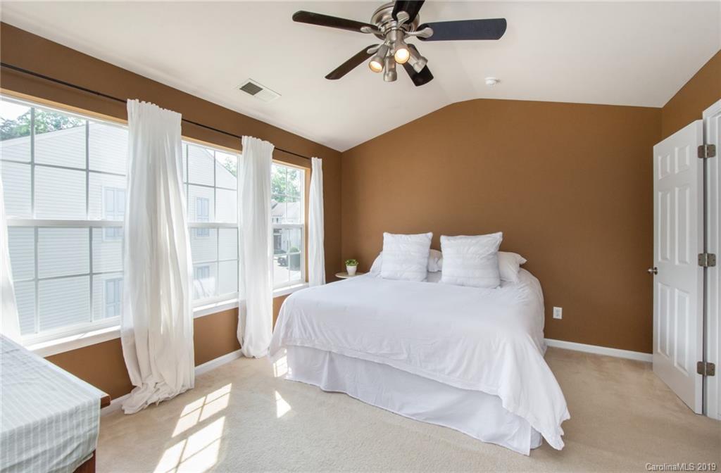 6864 Rothchild Drive Charlotte, NC 28270 - Photo 22 of 36 a bedroom with a large bed and a large window