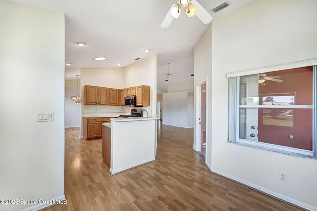 a kitchen with stainless steel appliances granite countertop a sink stove and microwave
