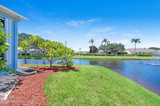 a view of a lake with a house in the background