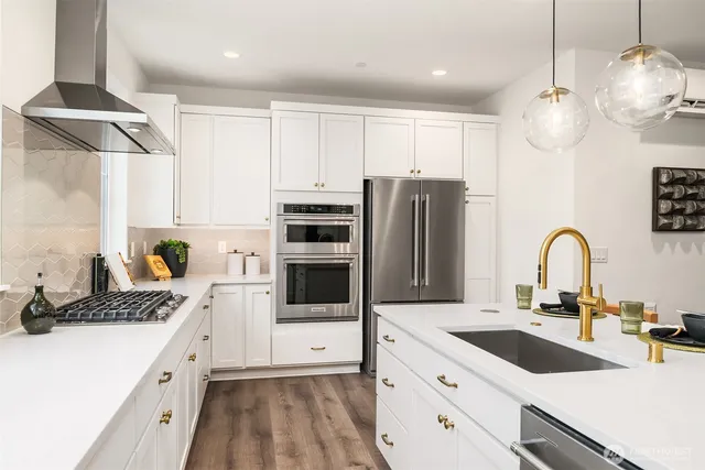 a kitchen with a refrigerator and a stove