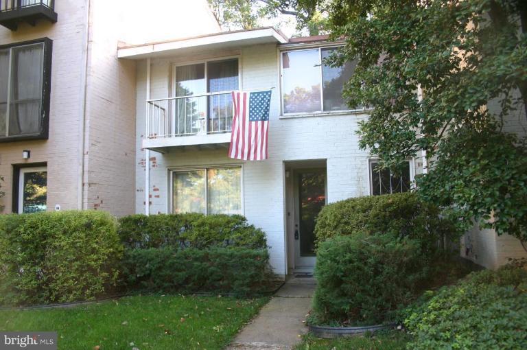 11449 Waterview Cluster Reston, VA 20190 - Photo 1 of 8 a front view of a house with garden