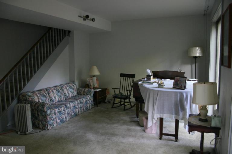 11449 Waterview Cluster Reston, VA 20190 - Photo 2 of 8 a bed room with furniture and a lamp