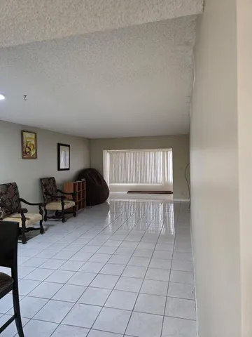 a kitchen with a sink a refrigerator and cabinets