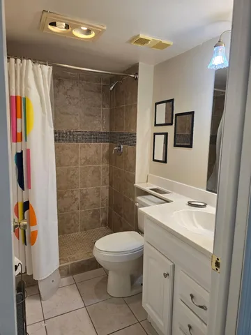 a bathroom with a toilet a sink and a shower