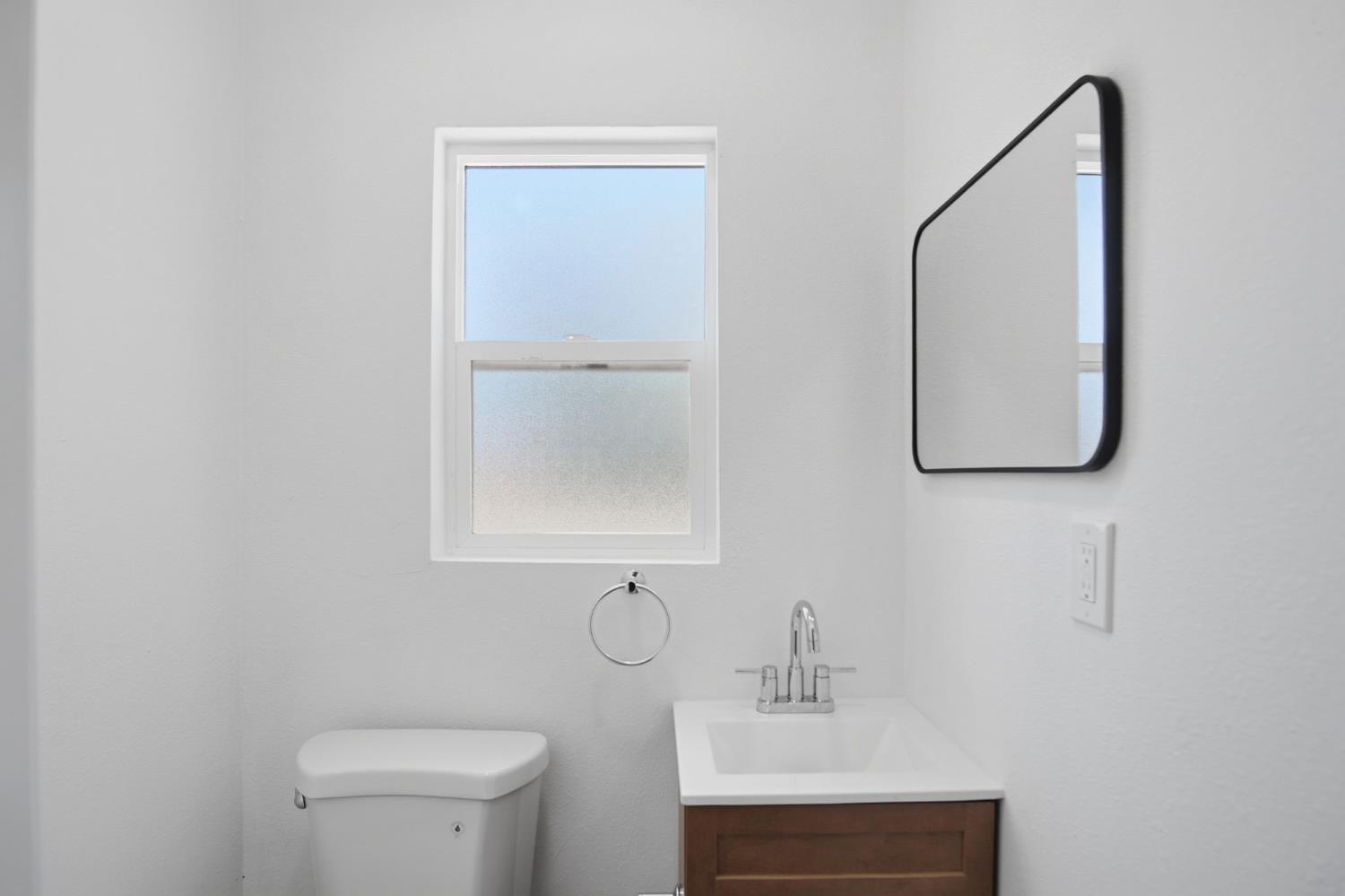 1451 Kent Way Modesto, CA 95355 - Photo 31 of 37 a bathroom with a toilet sink and mirror