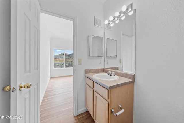 a bathroom with a sink a vanity and a mirror