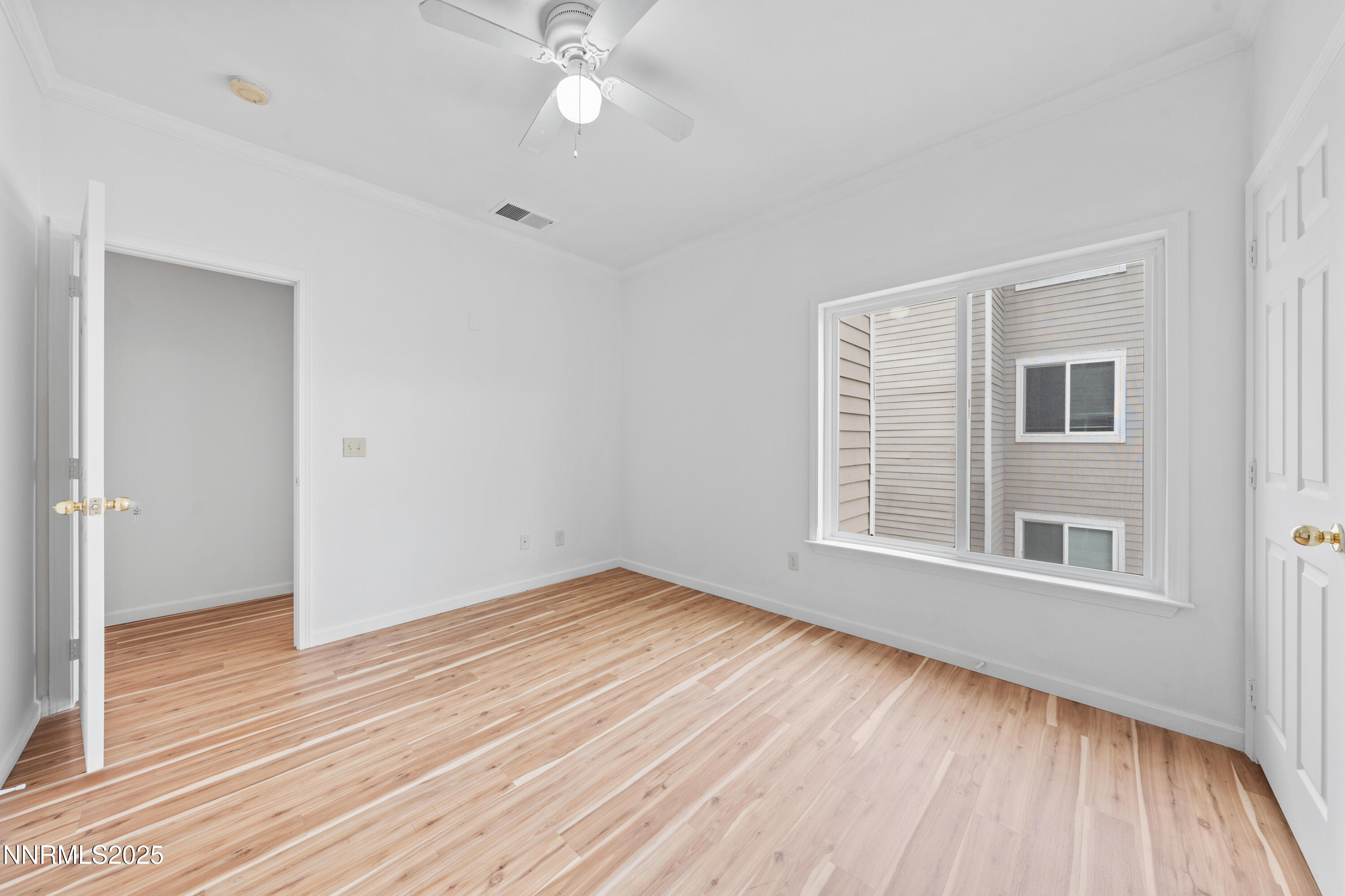 200 Talus Way, Unit 522 Reno, NV 89503 - Photo 27 of 40 a view of an empty room with wooden floor and a window