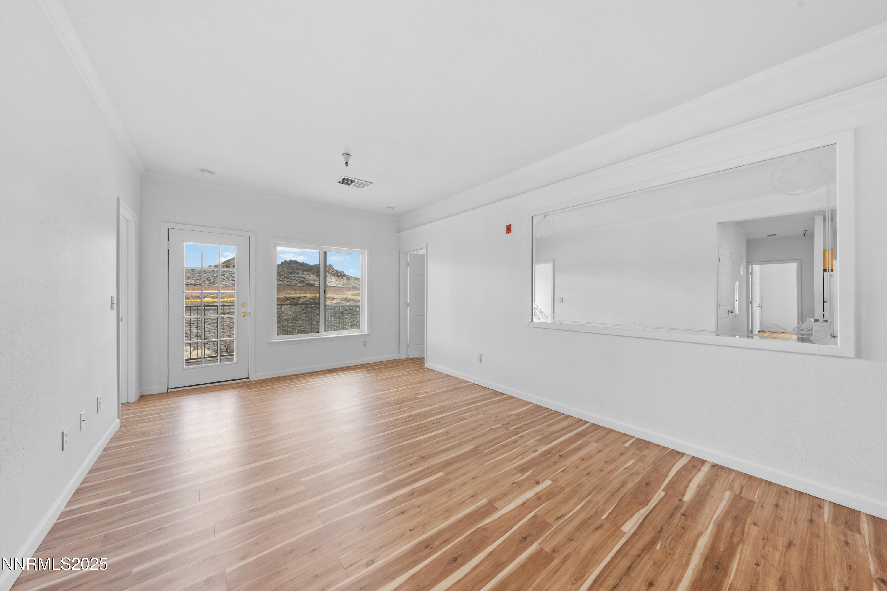 200 Talus Way, Unit 522 Reno, NV 89503 - Photo 5 of 40 a view of an empty room with window and wooden floor