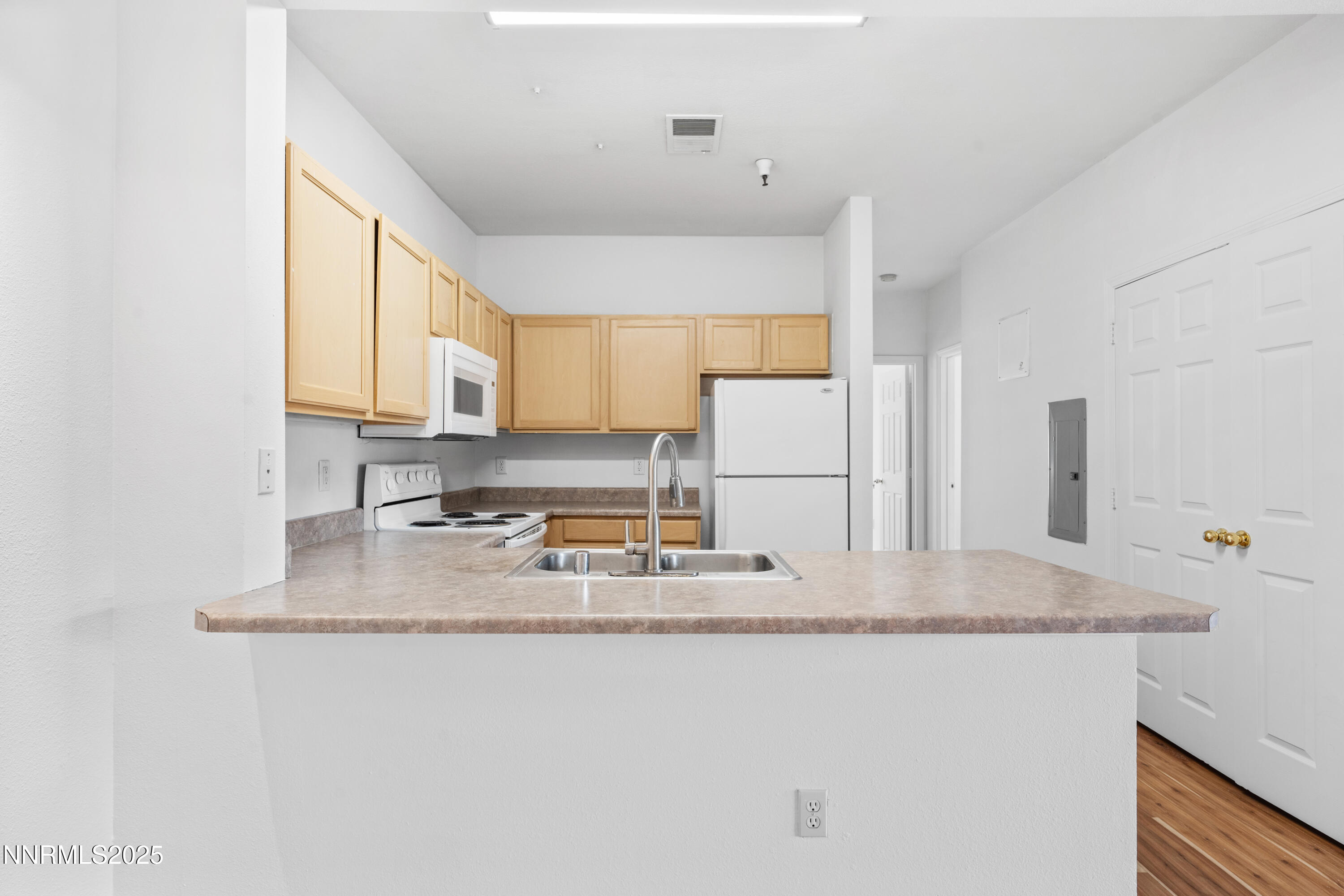 200 Talus Way, Unit 522 Reno, NV 89503 - Photo 8 of 40 a kitchen with kitchen island granite countertop a sink a stove a refrigerator a counter top space and cabinets