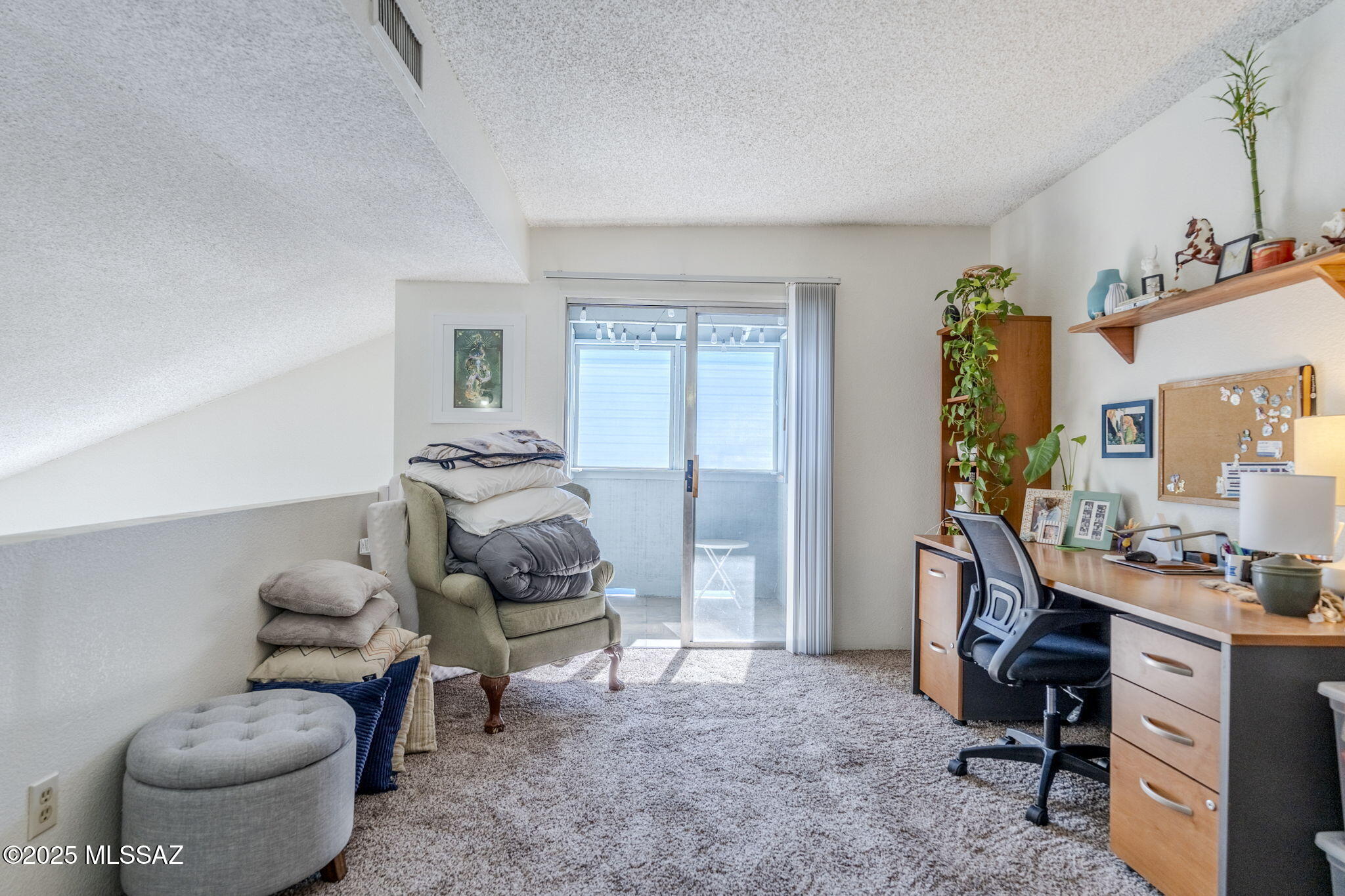 1131 West Roger Road Tucson, AZ 85705 - Photo 20 of 26 a room with furniture and a chair
