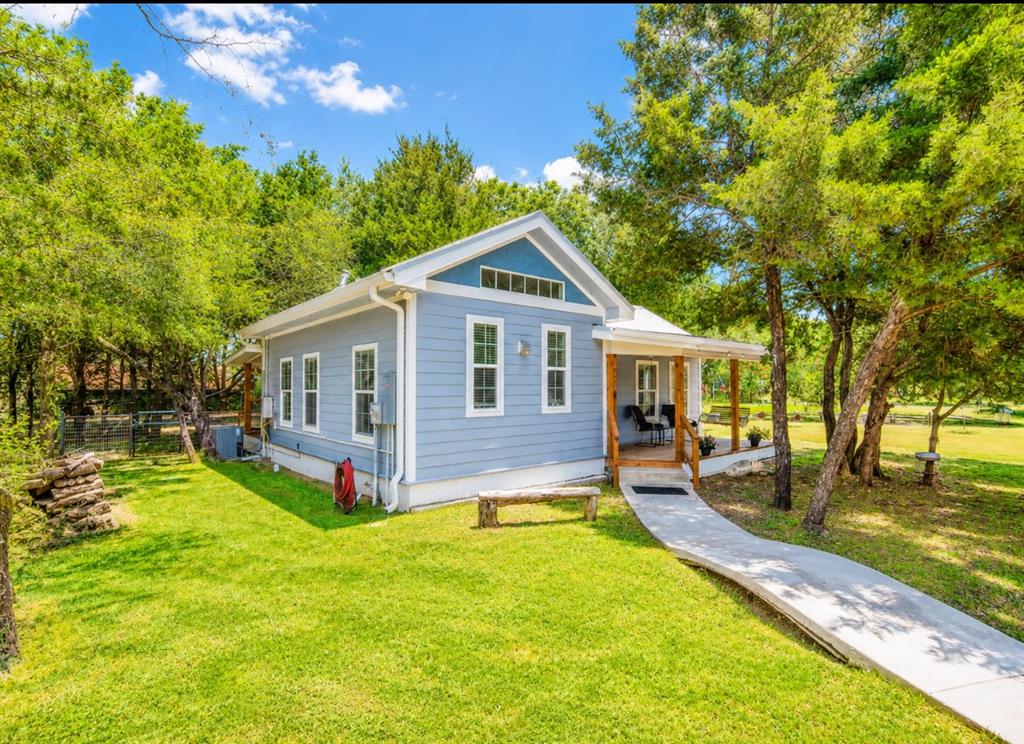 Light blue siding exterior featuring a covered front porch with exposed wood columns