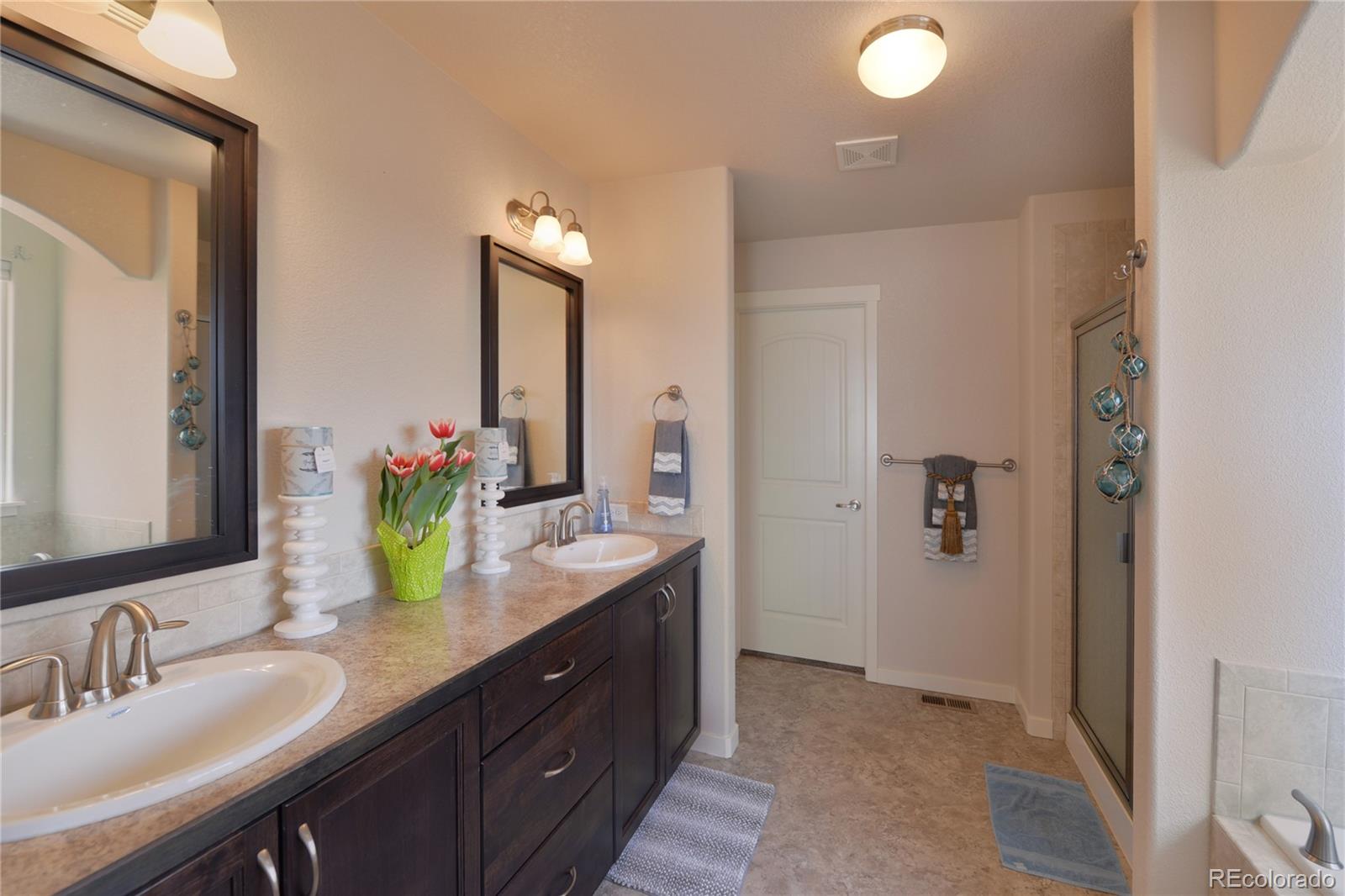 1643 Alpine Avenue Berthoud, CO 80513 - Photo 14 of 40 a bathroom with a granite countertop sink and a mirror