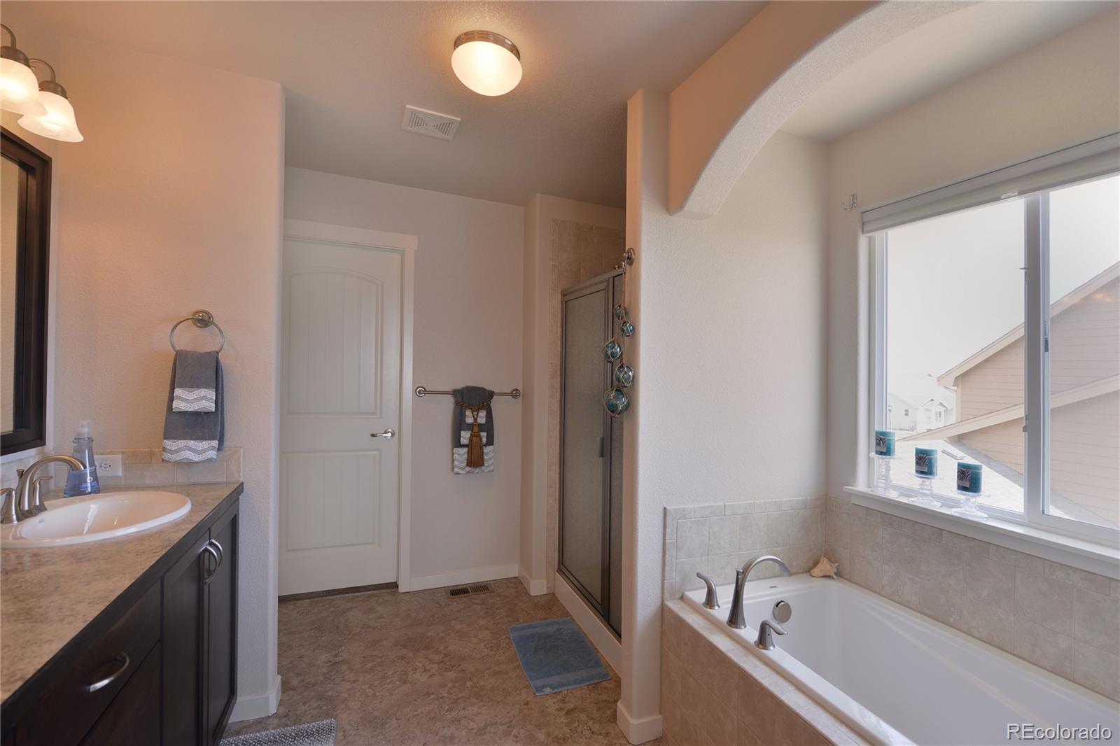 1643 Alpine Avenue Berthoud, CO 80513 - Photo 15 of 40 a bathroom with a tub sink and mirror