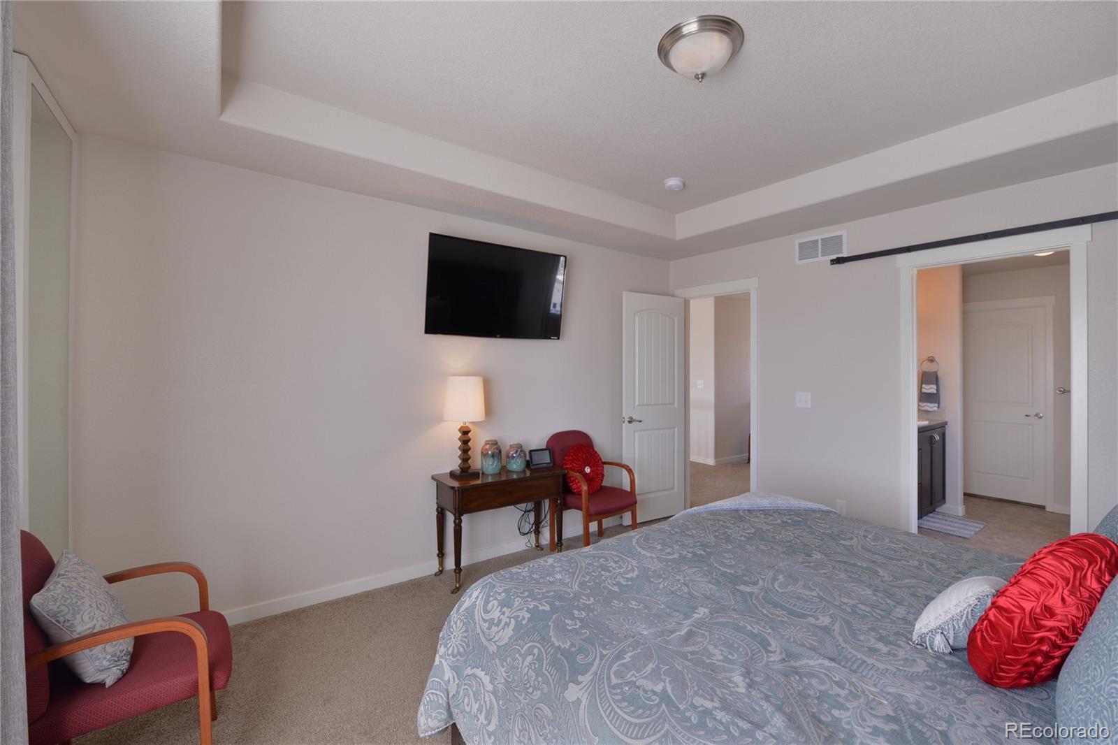 1643 Alpine Avenue Berthoud, CO 80513 - Photo 17 of 40 a bedroom with a bed and a flat screen tv