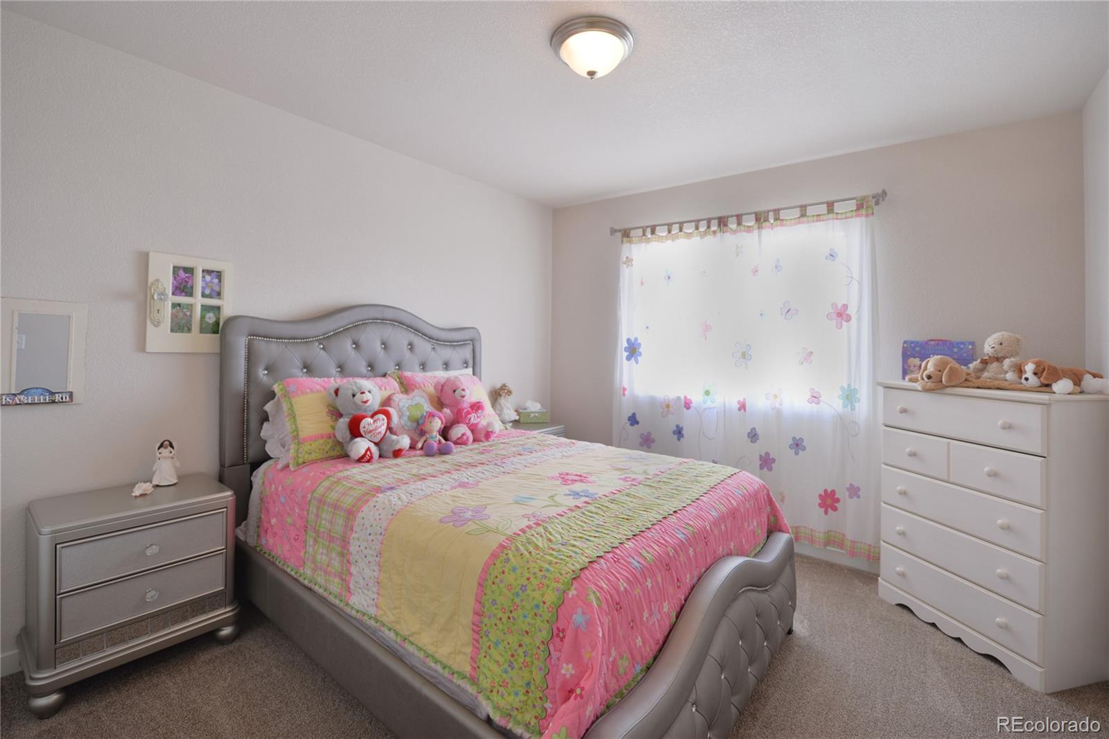 1643 Alpine Avenue Berthoud, CO 80513 - Photo 18 of 40 a bedroom with a bed and a window
