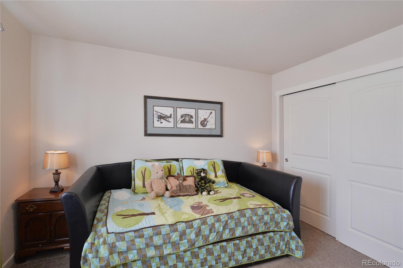 1643 Alpine Avenue Berthoud, CO 80513 - Photo 19 of 40 a bedroom with a bed and wooden floor