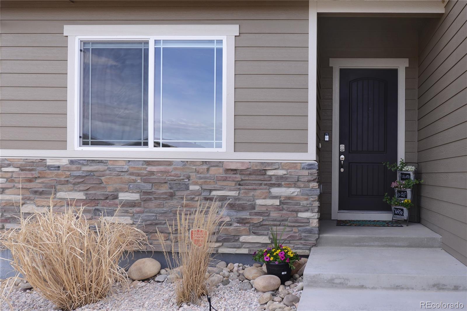 1643 Alpine Avenue Berthoud, CO 80513 - Photo 2 of 40 a front view of a house with a yard