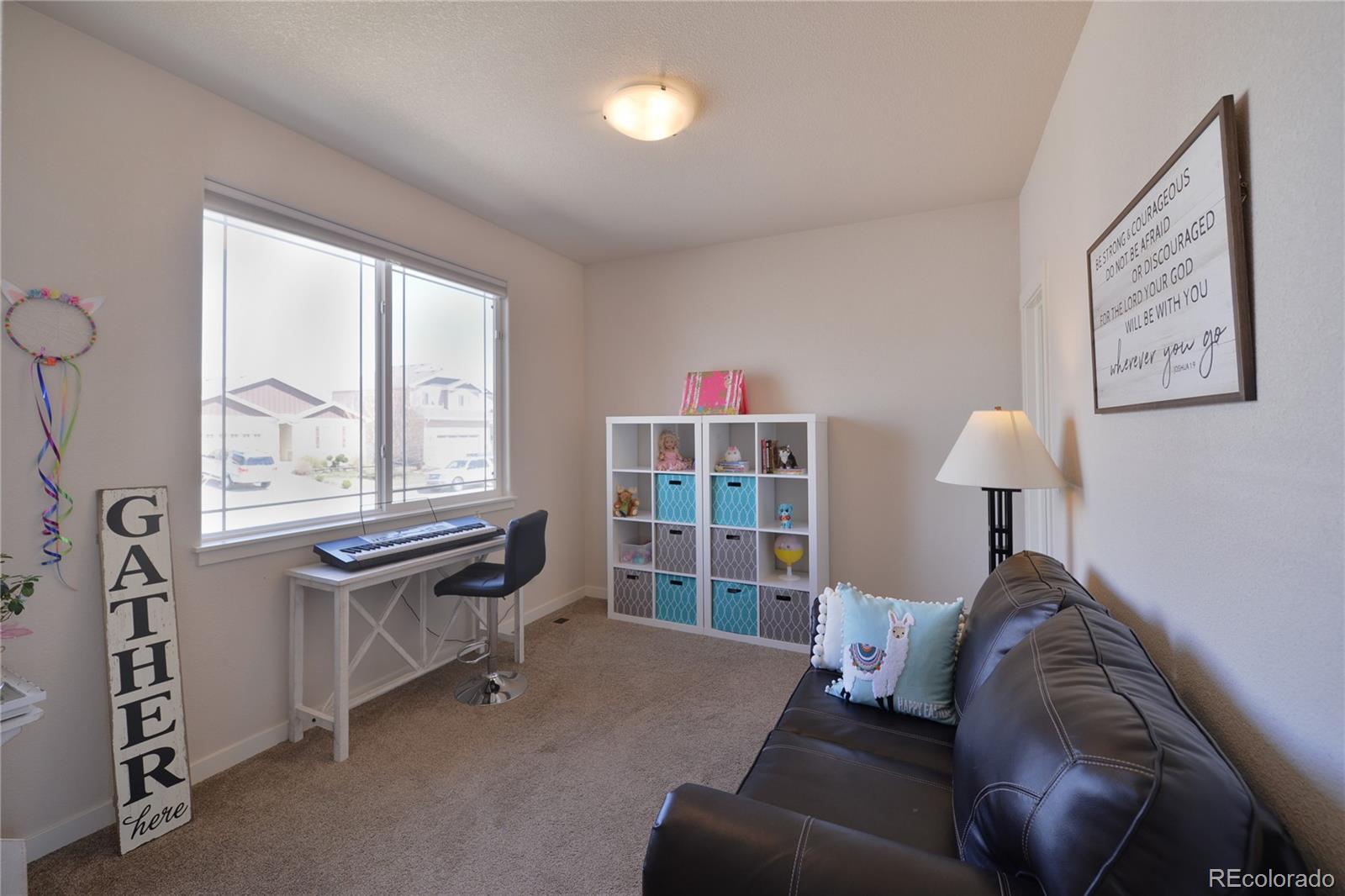 1643 Alpine Avenue Berthoud, CO 80513 - Photo 26 of 40 a bed room with furniture and a window