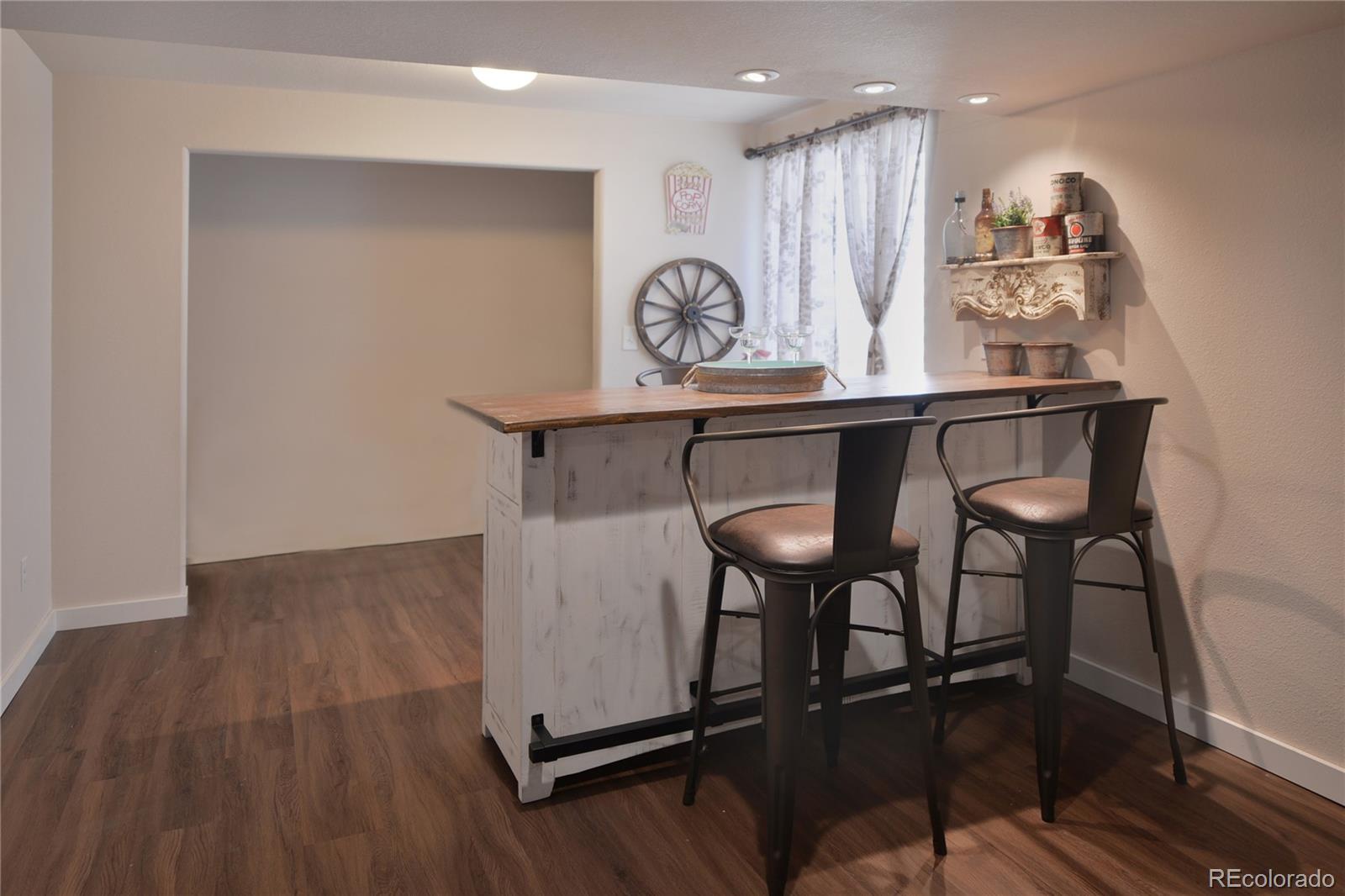 1643 Alpine Avenue Berthoud, CO 80513 - Photo 30 of 40 a view of a kitchen with kitchen island hardwood floor and a sink
