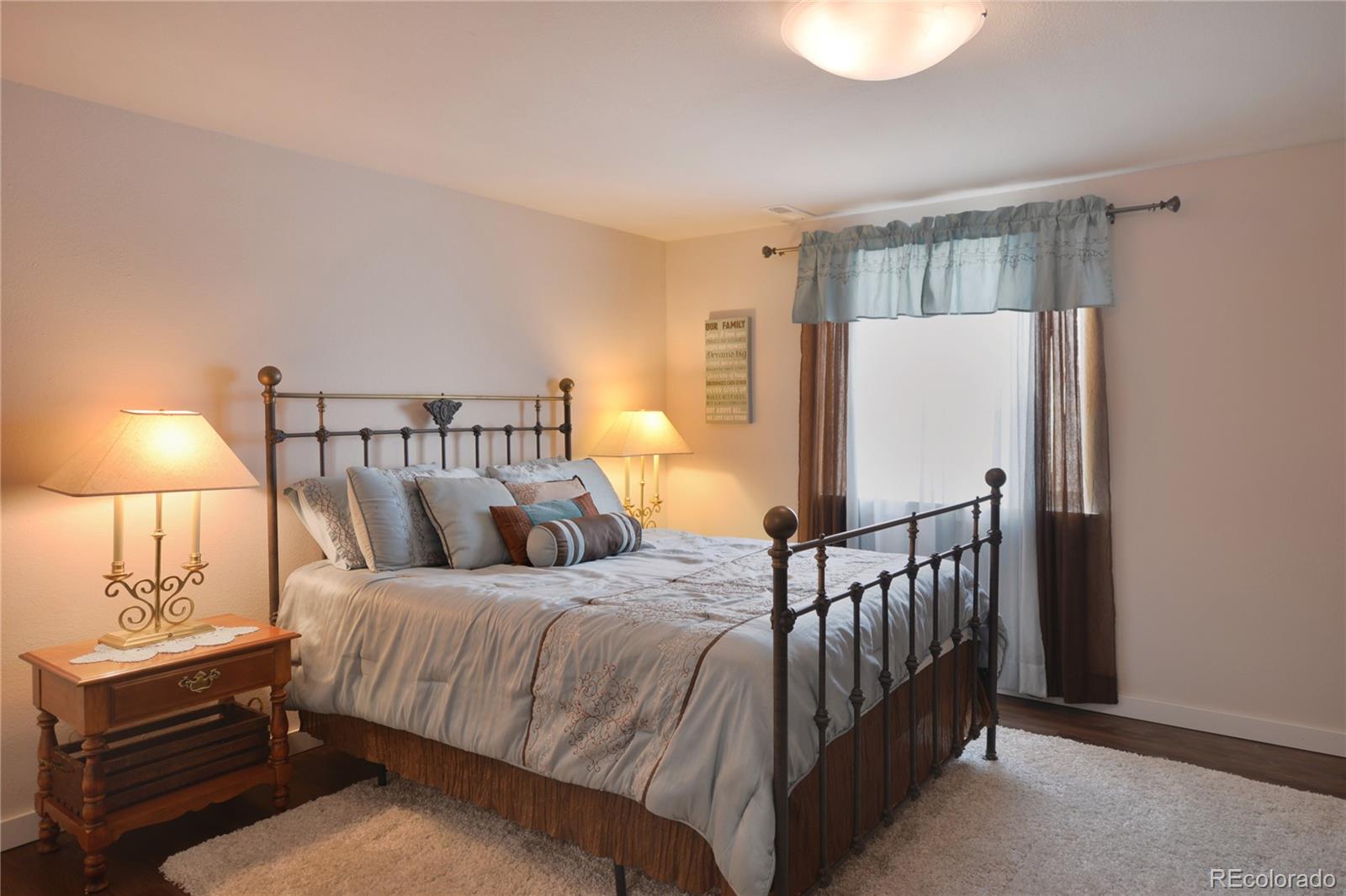 1643 Alpine Avenue Berthoud, CO 80513 - Photo 34 of 40 a bedroom with a bed and a lamp