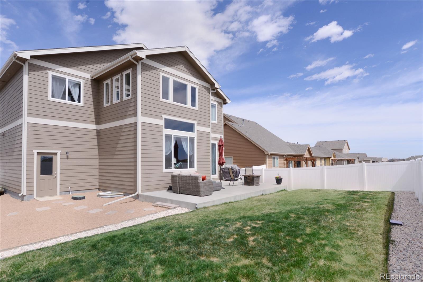 1643 Alpine Avenue Berthoud, CO 80513 - Photo 39 of 40 a front view of a house with a yard and garage