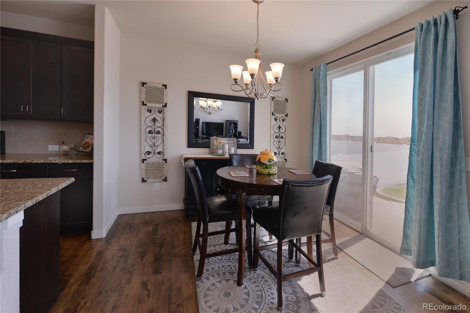 1643 Alpine Avenue Berthoud, CO 80513 - Photo 7 of 40 a view of a dining room with furniture window and wooden floor