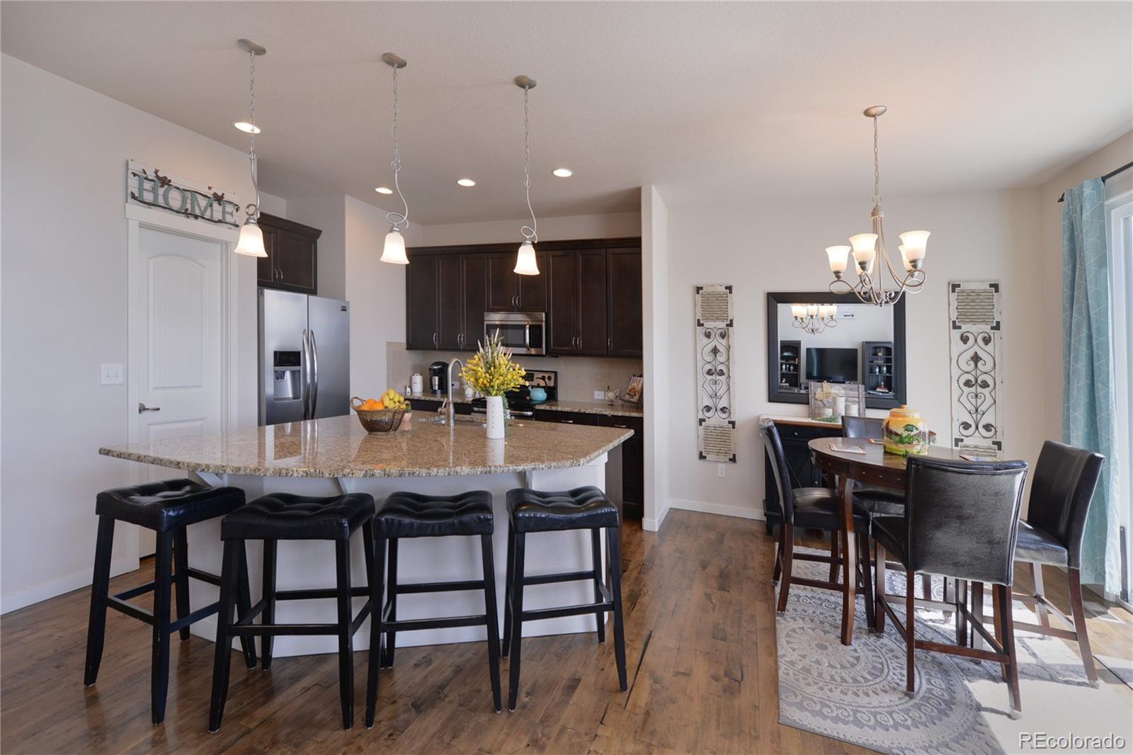 1643 Alpine Avenue Berthoud, CO 80513 - Photo 9 of 40 a kitchen with a dining table chairs and refrigerator