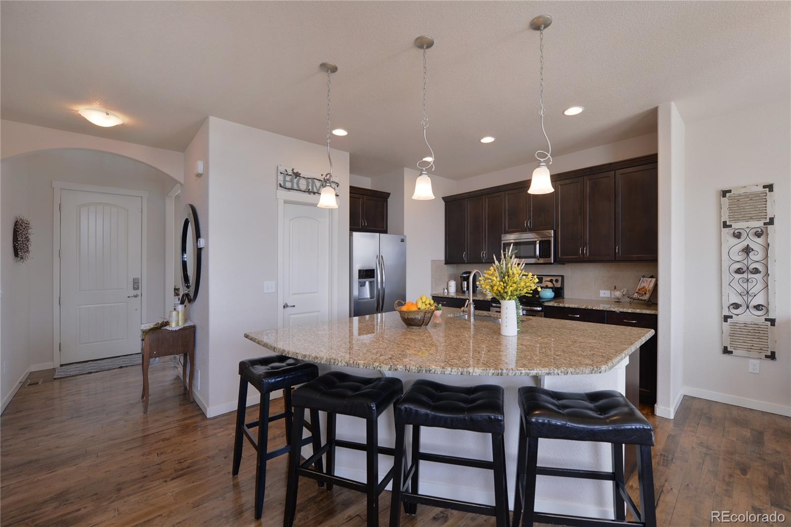 1643 Alpine Avenue Berthoud, CO 80513 - Photo 10 of 40 a kitchen with refrigerator dining table and chairs
