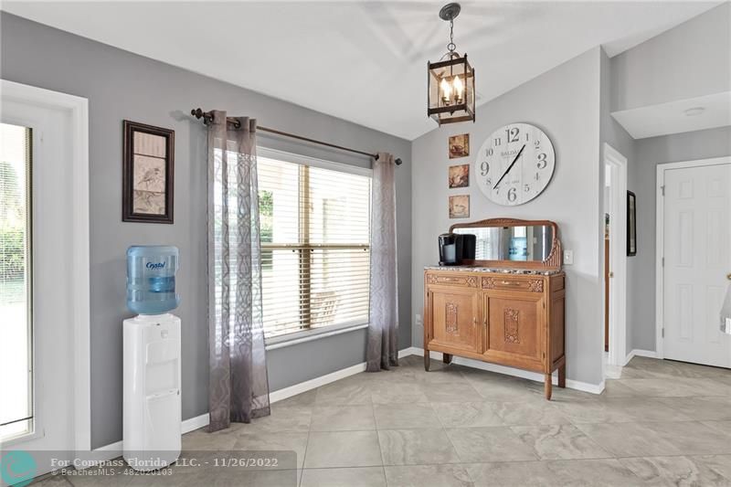 132 Drake Way Sebastian, FL 32958 - Photo 13 of 37 a view of a hallway with entryway windows chandelier and a kitchen view