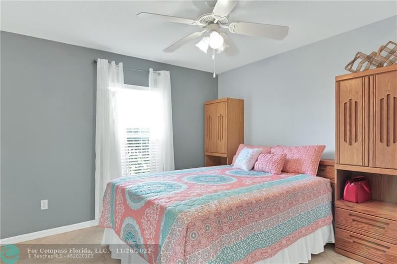 132 Drake Way Sebastian, FL 32958 - Photo 19 of 37 a bedroom with a bed and a chandelier