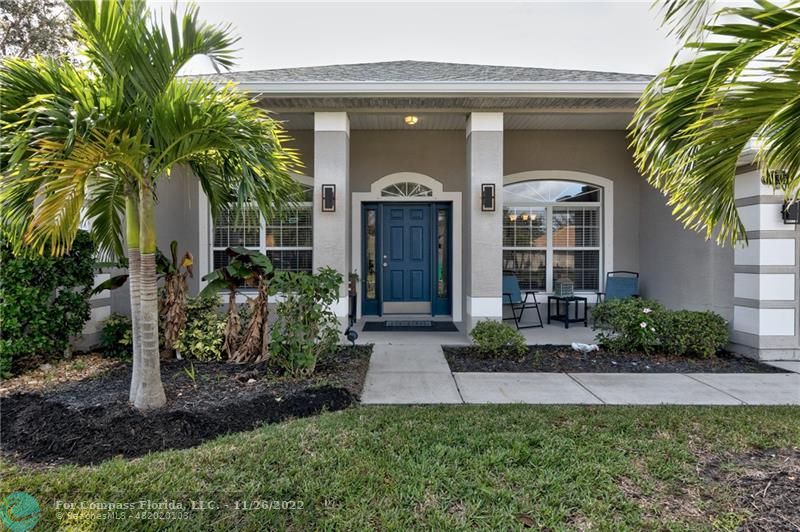 132 Drake Way Sebastian, FL 32958 - Photo 5 of 37 a front view of a house with a garden