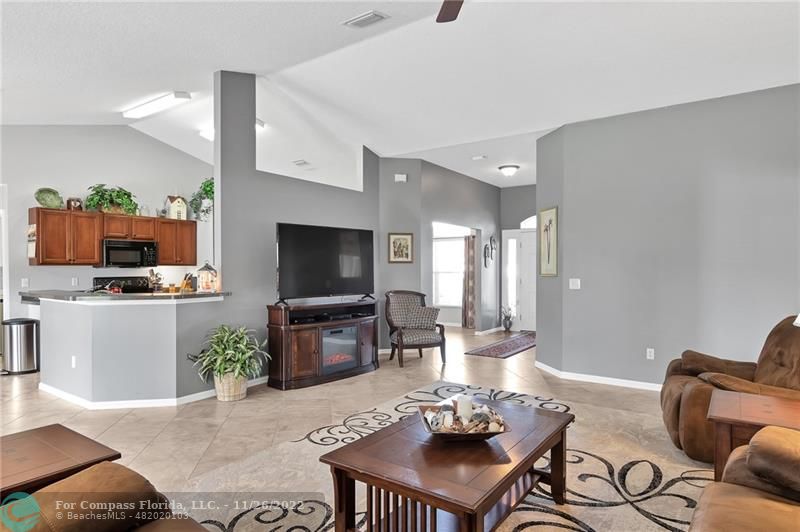 132 Drake Way Sebastian, FL 32958 - Photo 8 of 37 a living room with furniture a flat screen tv and kitchen view