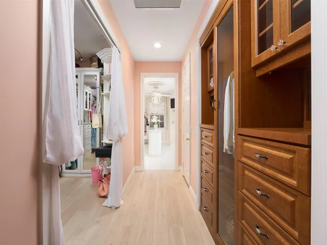 a view of walk in closet with clothes and shoes