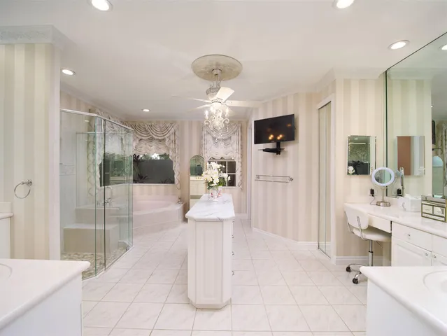 a bathroom with a double vanity sink mirror and shower