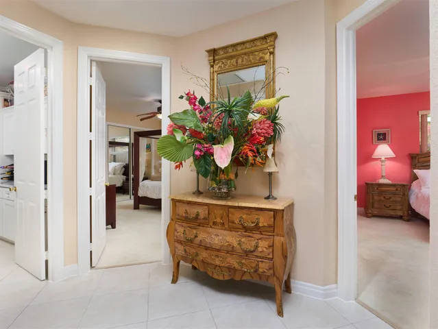 a bedroom with a bed and a flat tv screen on dresser
