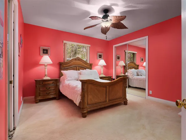 a bathroom with a granite countertop sink a mirror and shower