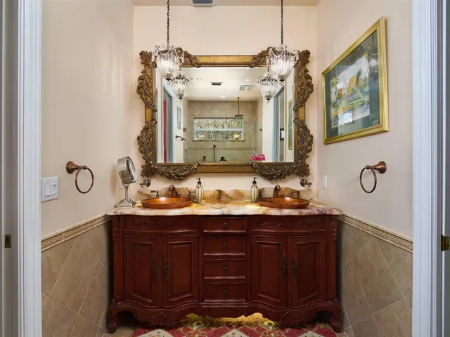 a kitchen with granite countertop kitchen island a sink stainless steel appliances and cabinets